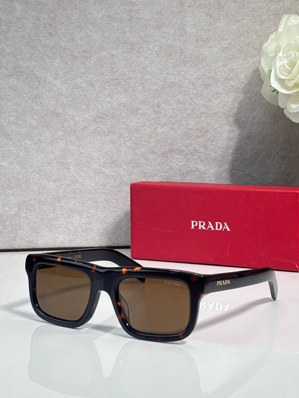 Prada glasses with black frame and warm tan lenses