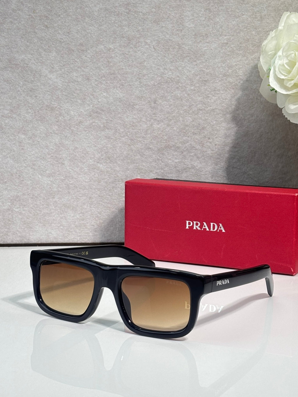 Prada glasses with black frame and tan lenses