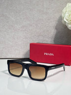 Prada glasses with black frame and tan lenses
