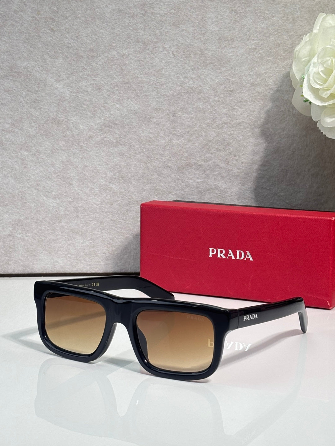 Prada glasses with black frame and tan lenses