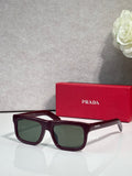 Prada glasses with burgundy frame and dark green lenses
