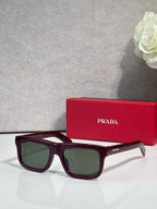 Prada glasses with burgundy frame and dark green lenses
