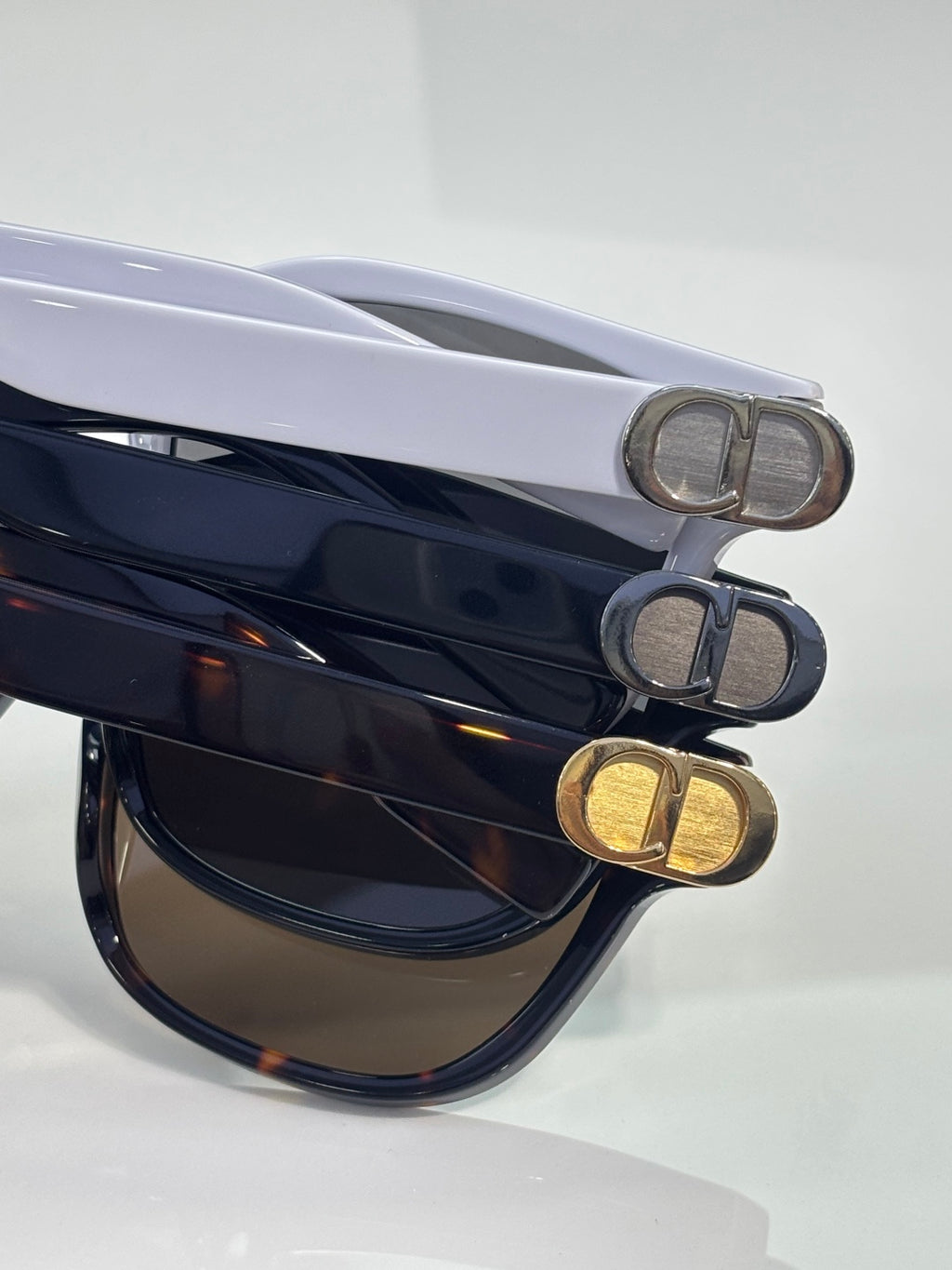 Dior sunglasses temples with metal D hardware on dark and blue acetate frames