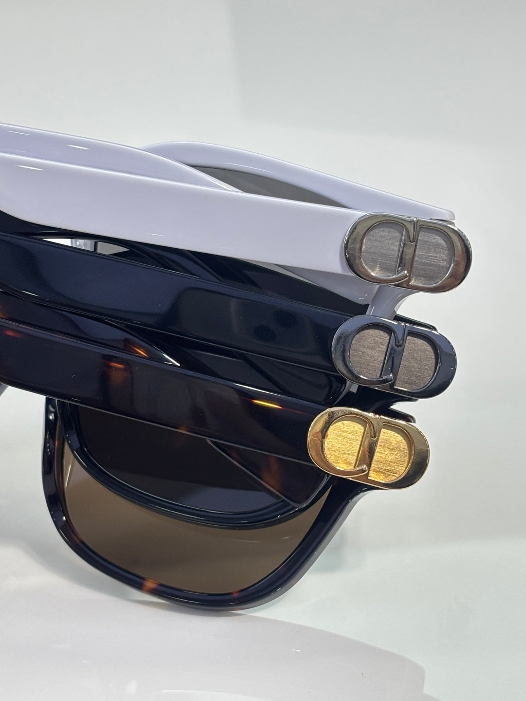 Dior sunglasses temples with metal D hardware on dark and blue acetate frames