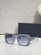 Slate blue square sunglasses with blue-tinted lenses and gold logo hinge