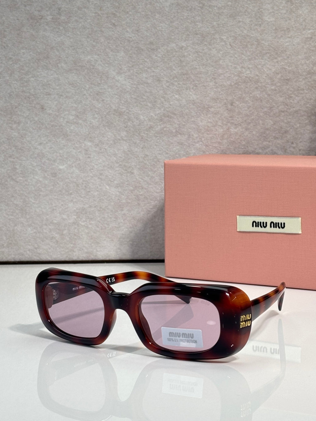 Dark tortoise full-frame sunglasses with rounded square lenses and logo arms