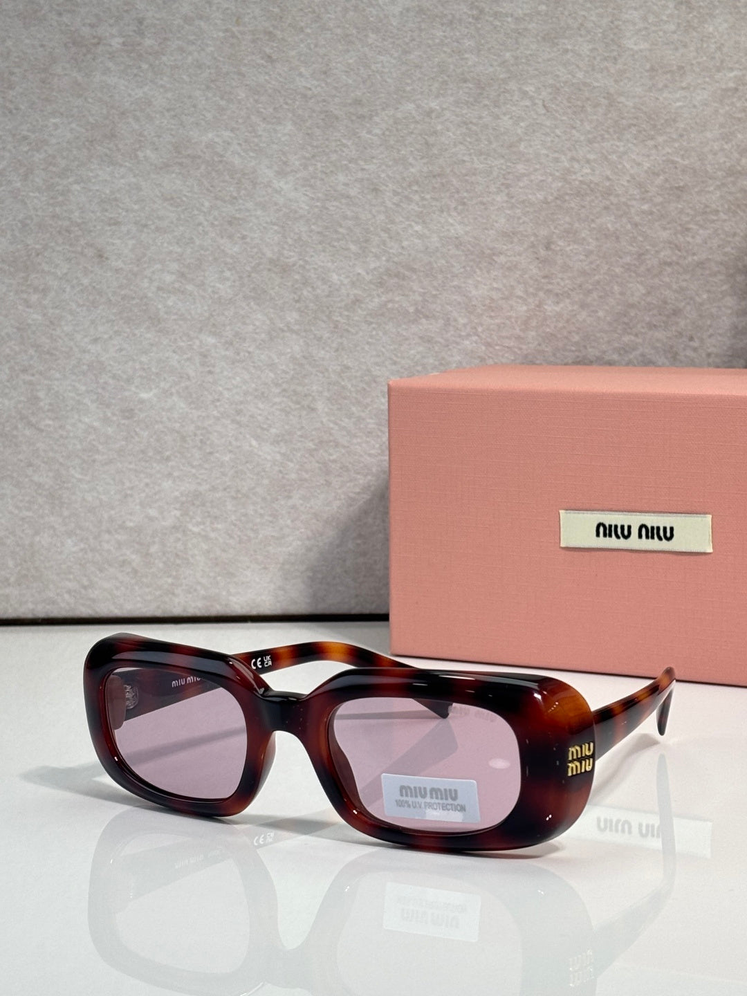 Dark tortoise full-frame sunglasses with rounded square lenses and logo arms