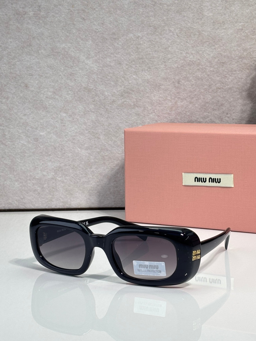 Black full-frame sunglasses with glossy finish and rounded square lenses