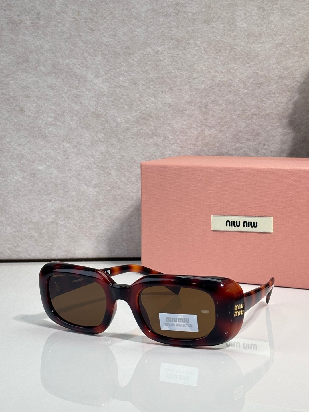Tortoise-pattern full-frame sunglasses with rounded square lenses and logo details