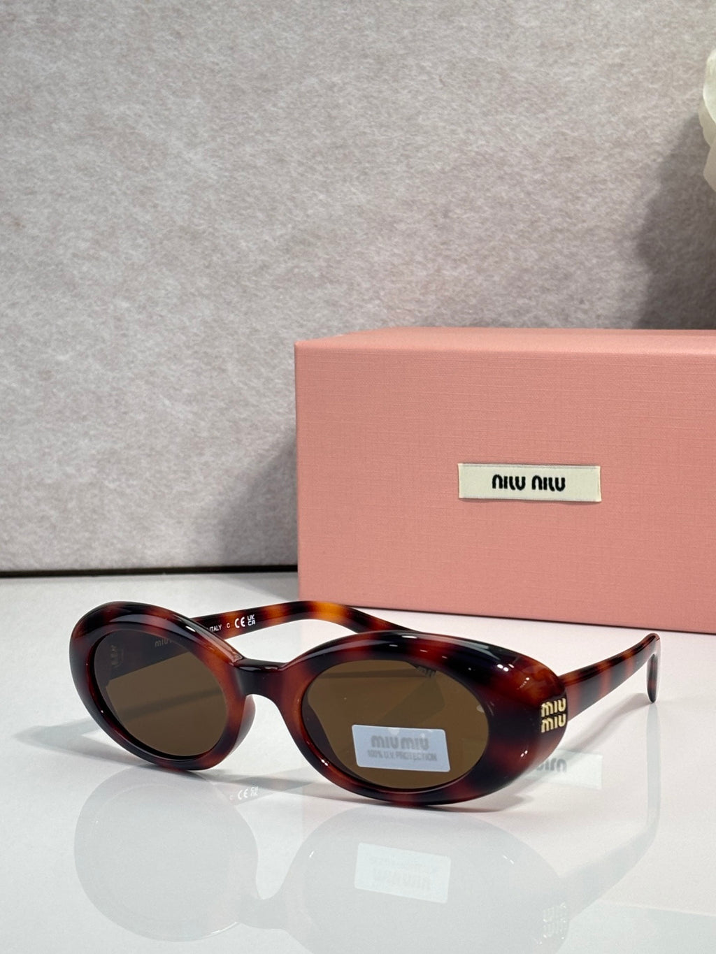 Round sunglasses with dark tortoiseshell frames and oval lenses