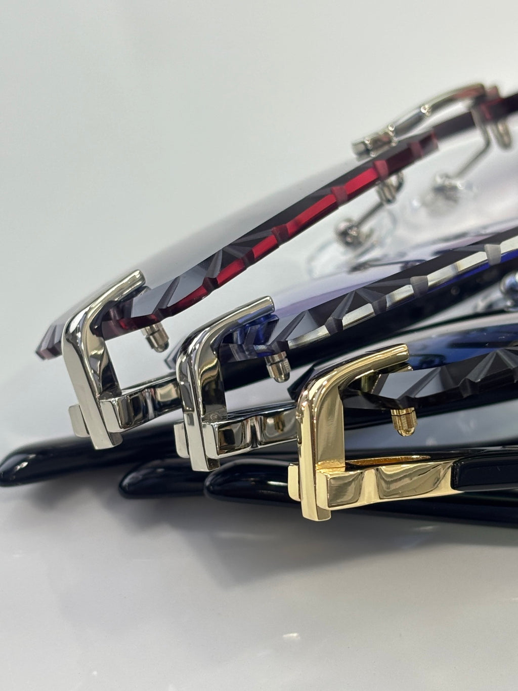 Cartier eyeglasses close-up of metal hinges and colored temples with gold and silver frames.