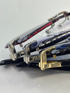 Cartier eyeglasses close-up of metal hinges and colored temples with gold and silver frames.