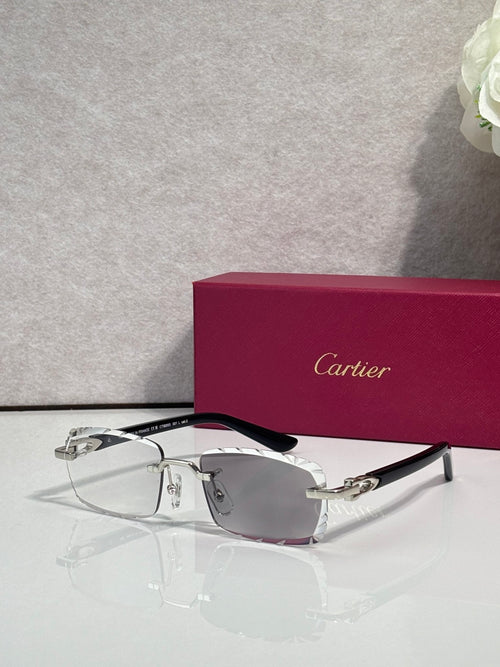 Cartier eyeglasses with clear lenses, silver metal frame, and black temple tips.