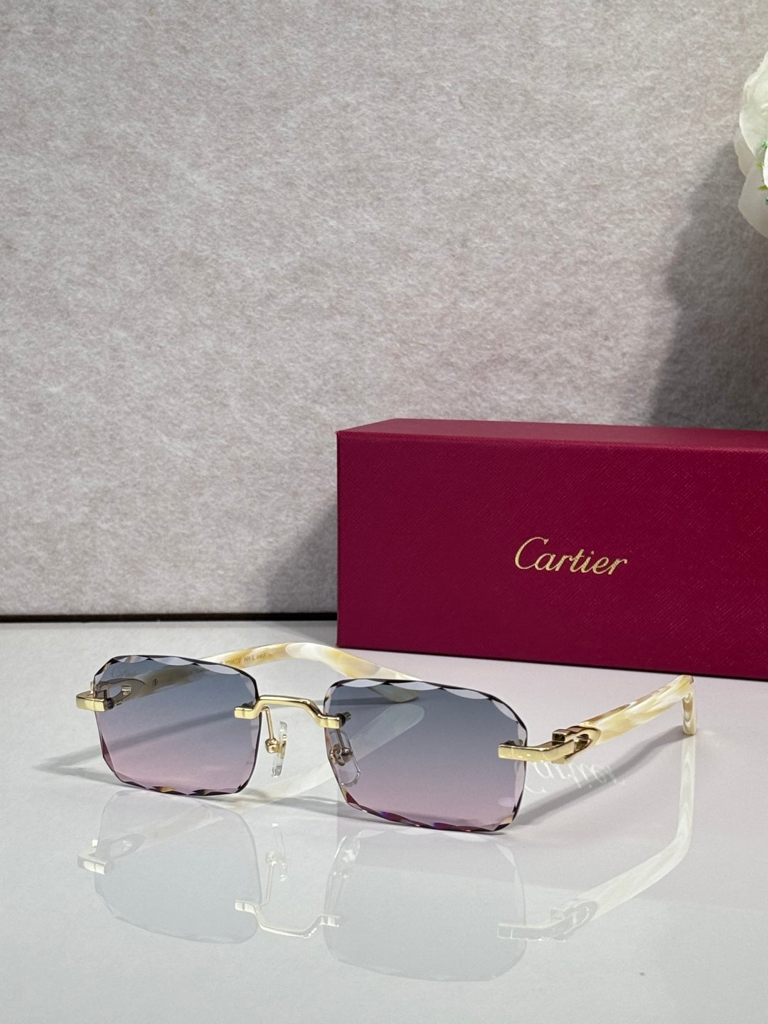 Cartier glasses with black frame, gold accents, clear lenses with mauve tint