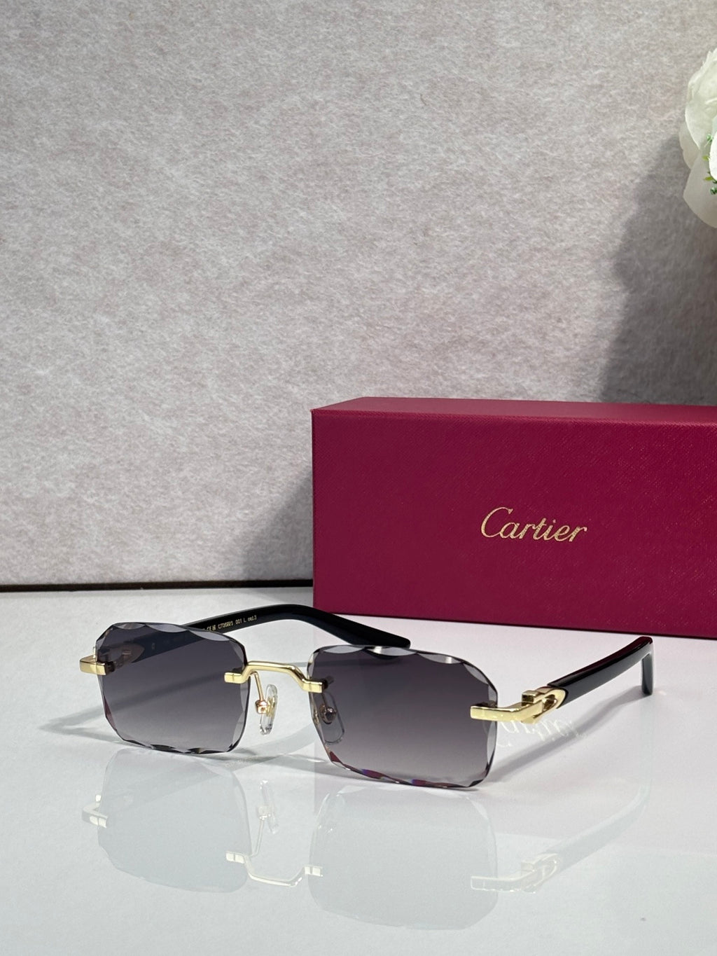 Cartier glasses with black frame, gold accents, clear lenses with dark gray tint