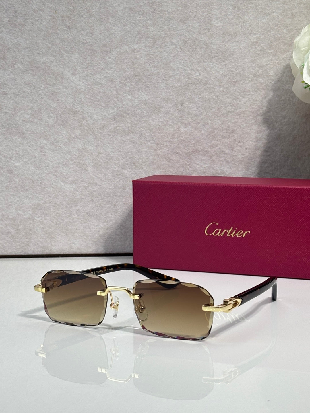 Cartier glasses with black frame, gold accents, clear lenses with brown tint