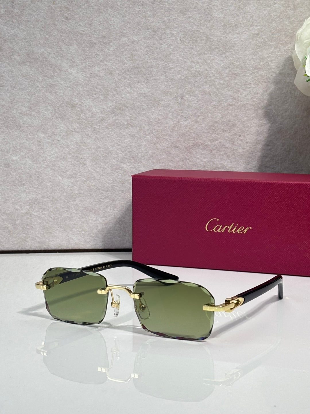 Cartier glasses with black frame, gold accents, clear lenses with olive tint