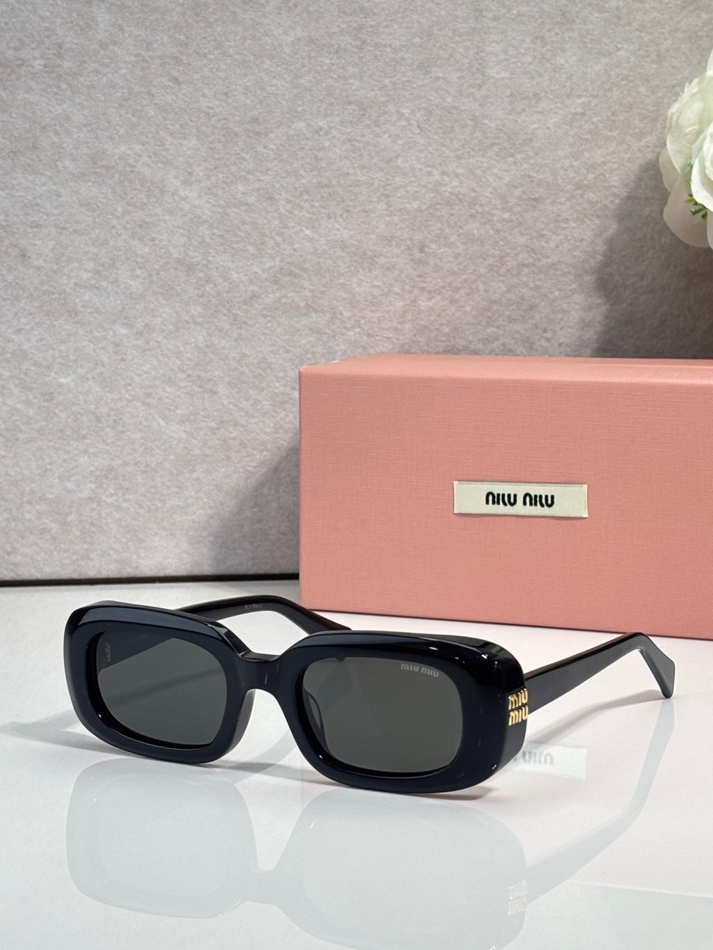 Glasses with black frame and dark tinted lenses, oval-rectangle style