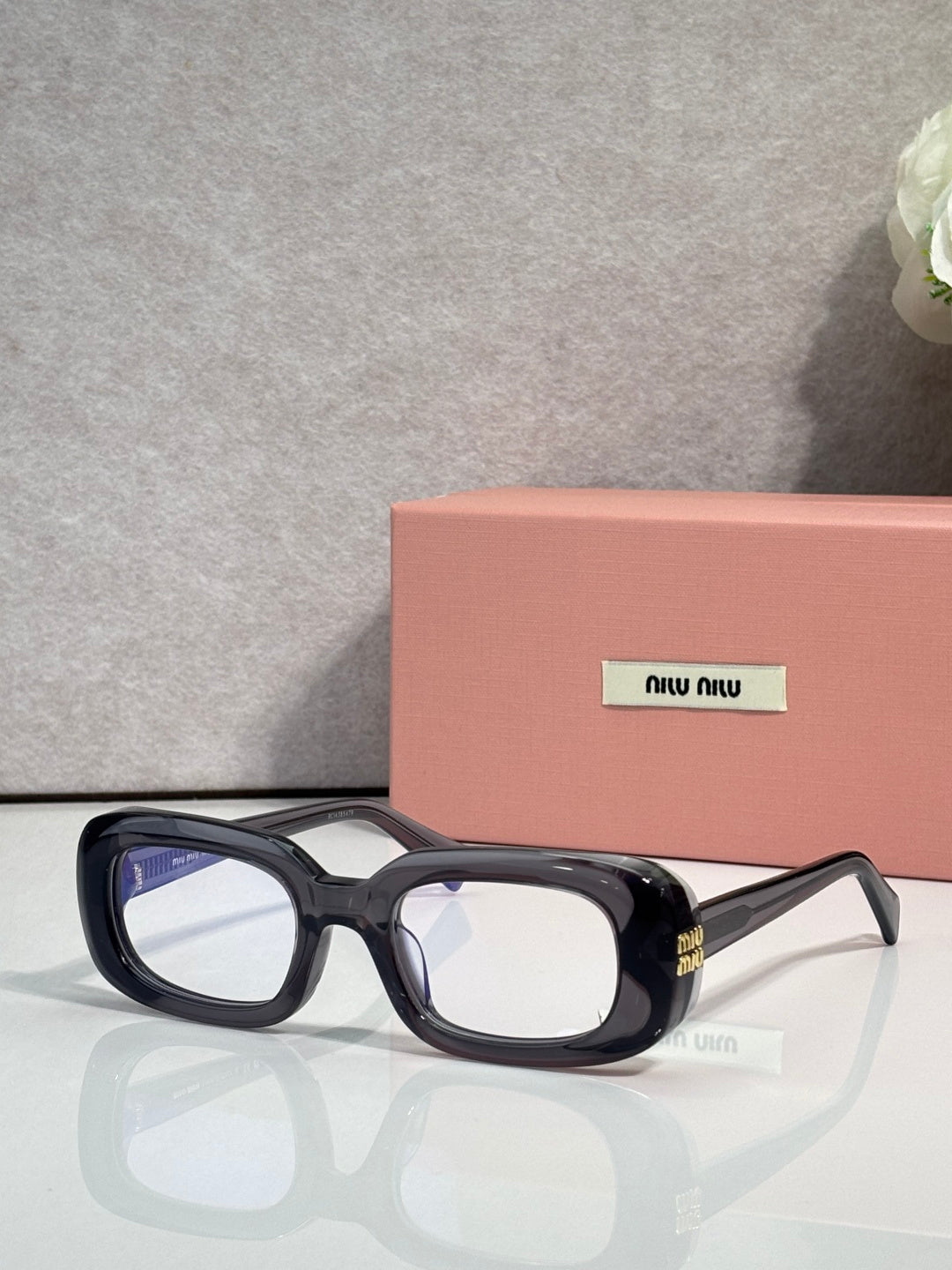 MiuMiu glasses with black frame and clear lenses, rectangular shape