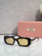 Glasses with black frame and tortoiseshell accents, yellow-tinted rectangular lenses