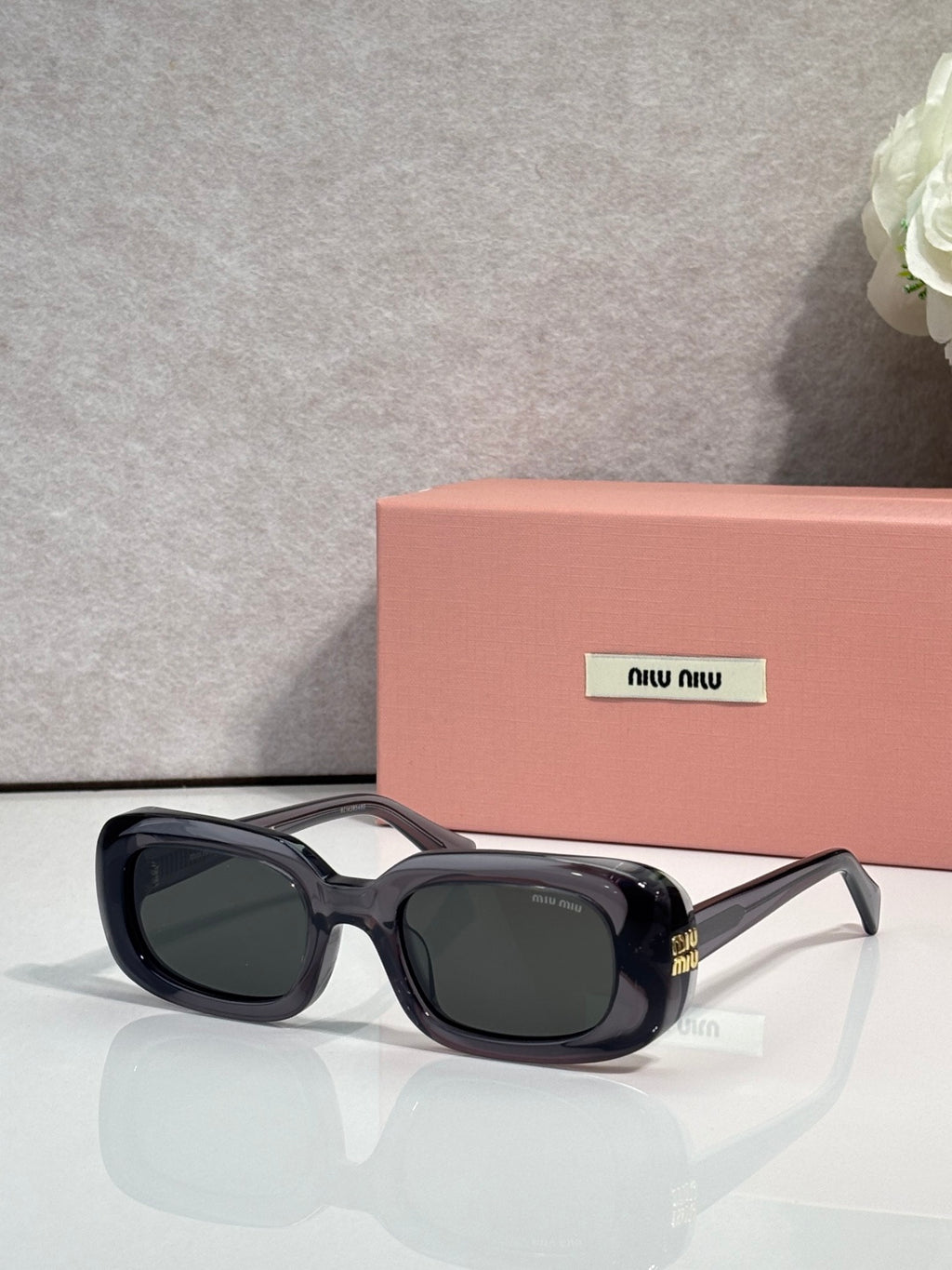 Glasses with black frame and dark lenses, square-rectangular shape