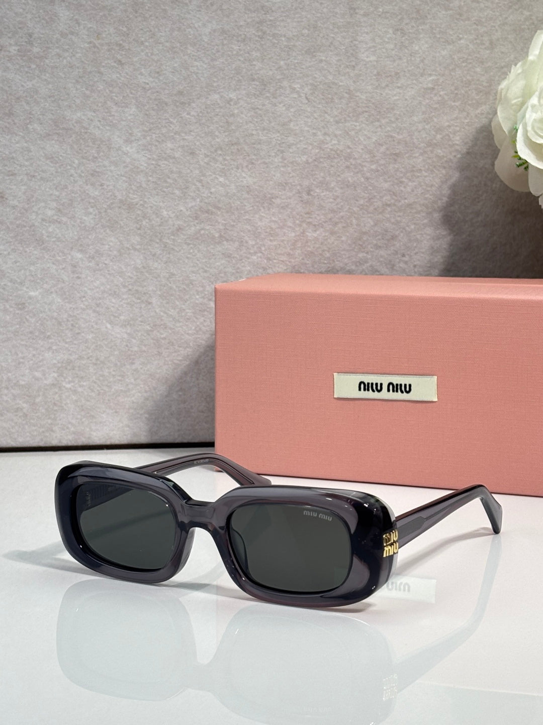 Glasses with black frame and dark lenses, square-rectangular shape