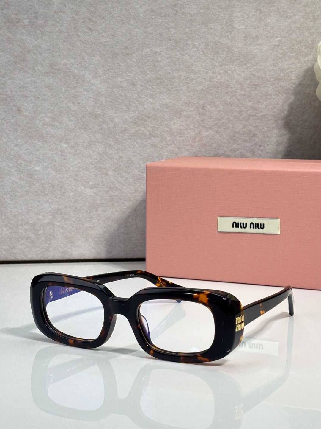 Glasses with black frame and tortoiseshell accents, clear rectangular lenses