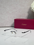 Dark metal eyeglasses with clear lenses, Cartier frame details.