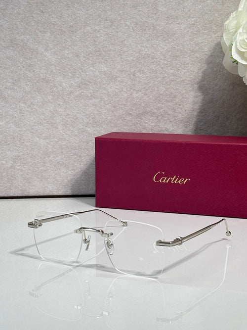 Silver metal eyeglasses with clear lenses, Cartier frame details.