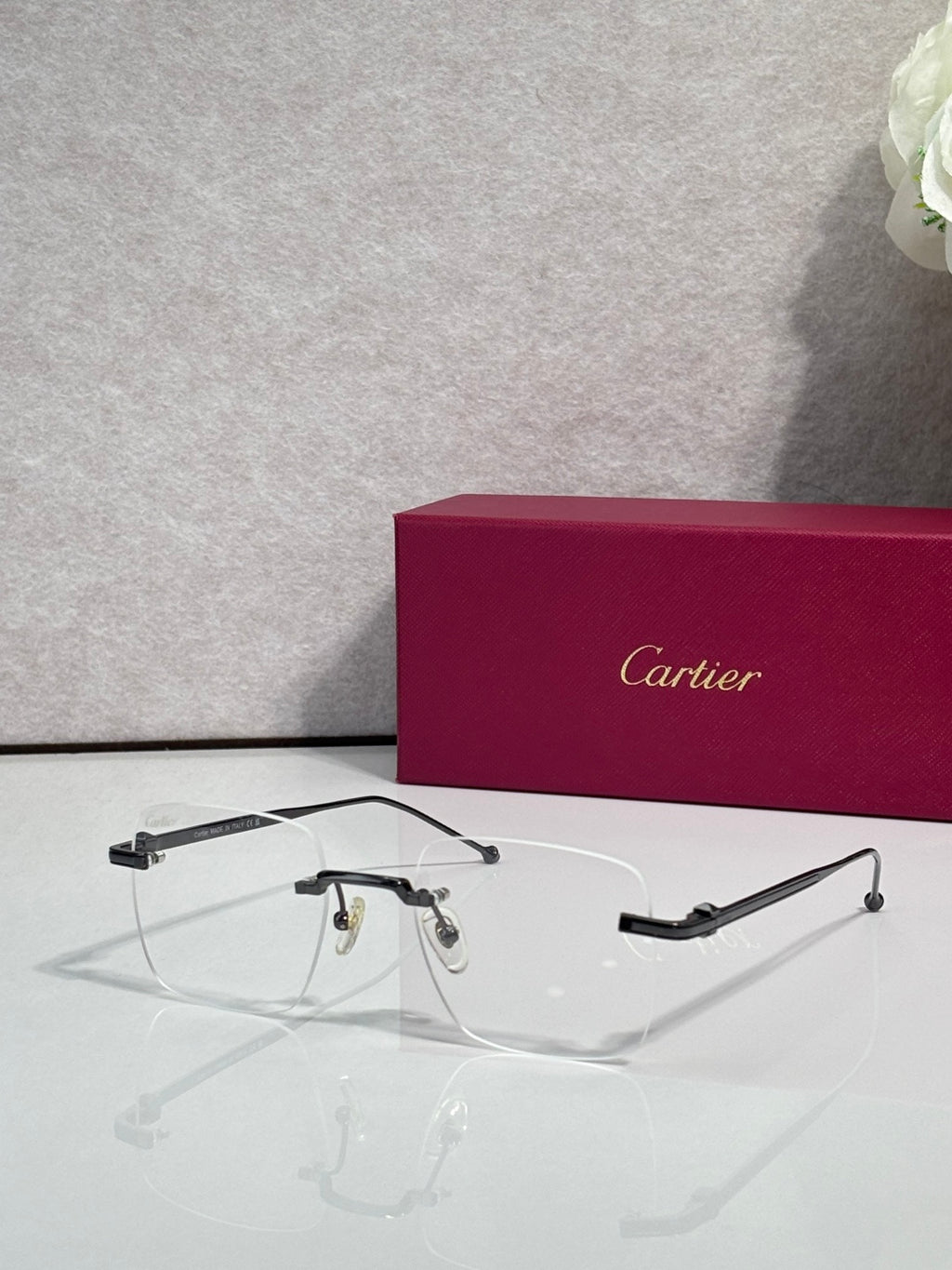 Black-accent eyeglasses with clear lenses, Cartier frame details.
