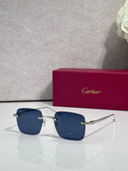 Blue-tinted sunglasses with dark metal frame, Cartier temple details.