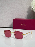 Cartier sunglasses with burgundy tinted lenses and gold frame, clear side arms.