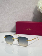 Cartier sunglasses with blue gradient lenses and gold frame, clear side arms.