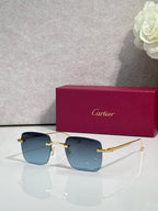 Cartier sunglasses with light blue gradient lenses and gold frame, clear side arms.