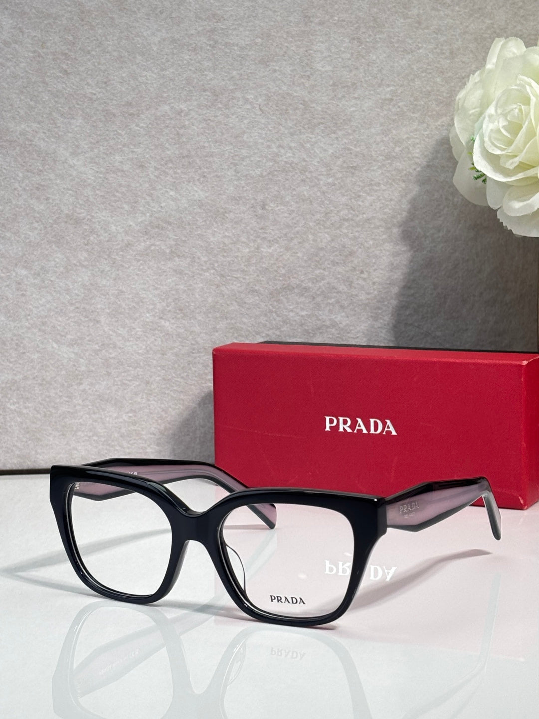 Prada black eyeglasses with rectangular frames and smoky purple arms