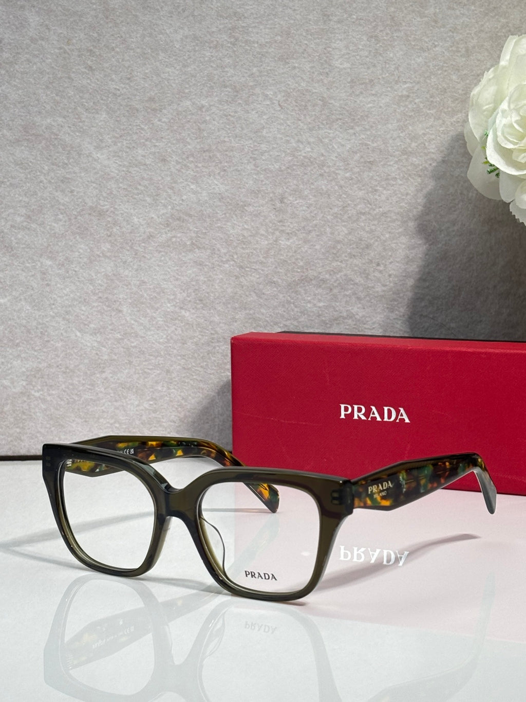 Prada dark eyeglasses with rectangular frames and tortoise temples