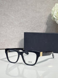 Black eyeglass frame with square lenses, white inner detail, gold temple logo