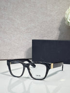 Black eyeglass frame with rounded square lenses, gold temple bar