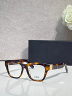 Tortoiseshell eyeglass frame with square lenses and gold temple accents