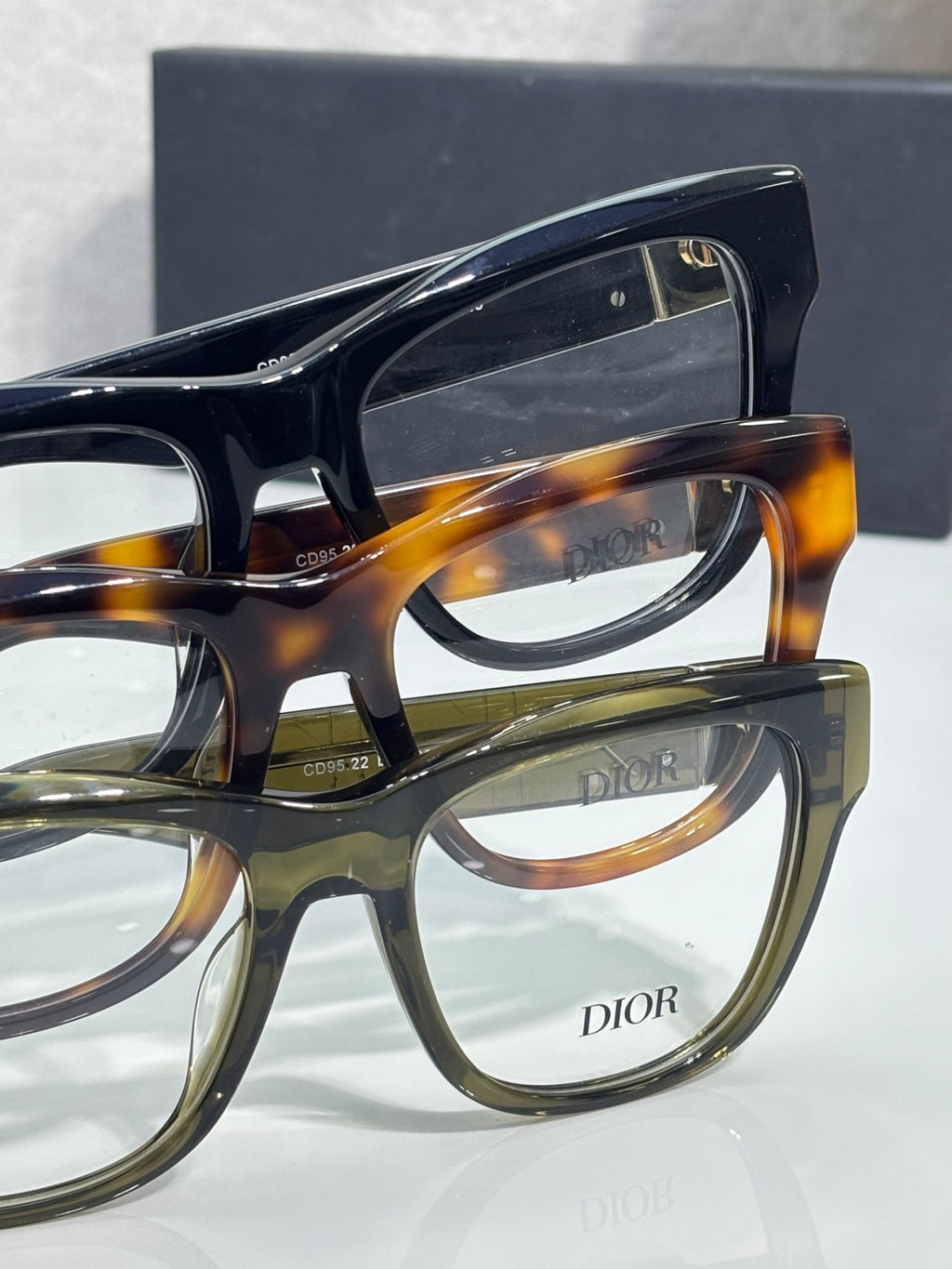 Layered eyeglasses with dark blue top frame and tortoiseshell front frame