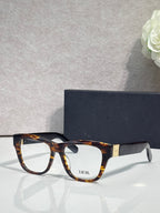 Tortoiseshell eyeglass frame with square lenses, gold bridge and temple logo