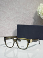 Olive-green eyeglass frame with square lenses, gold temple logo details