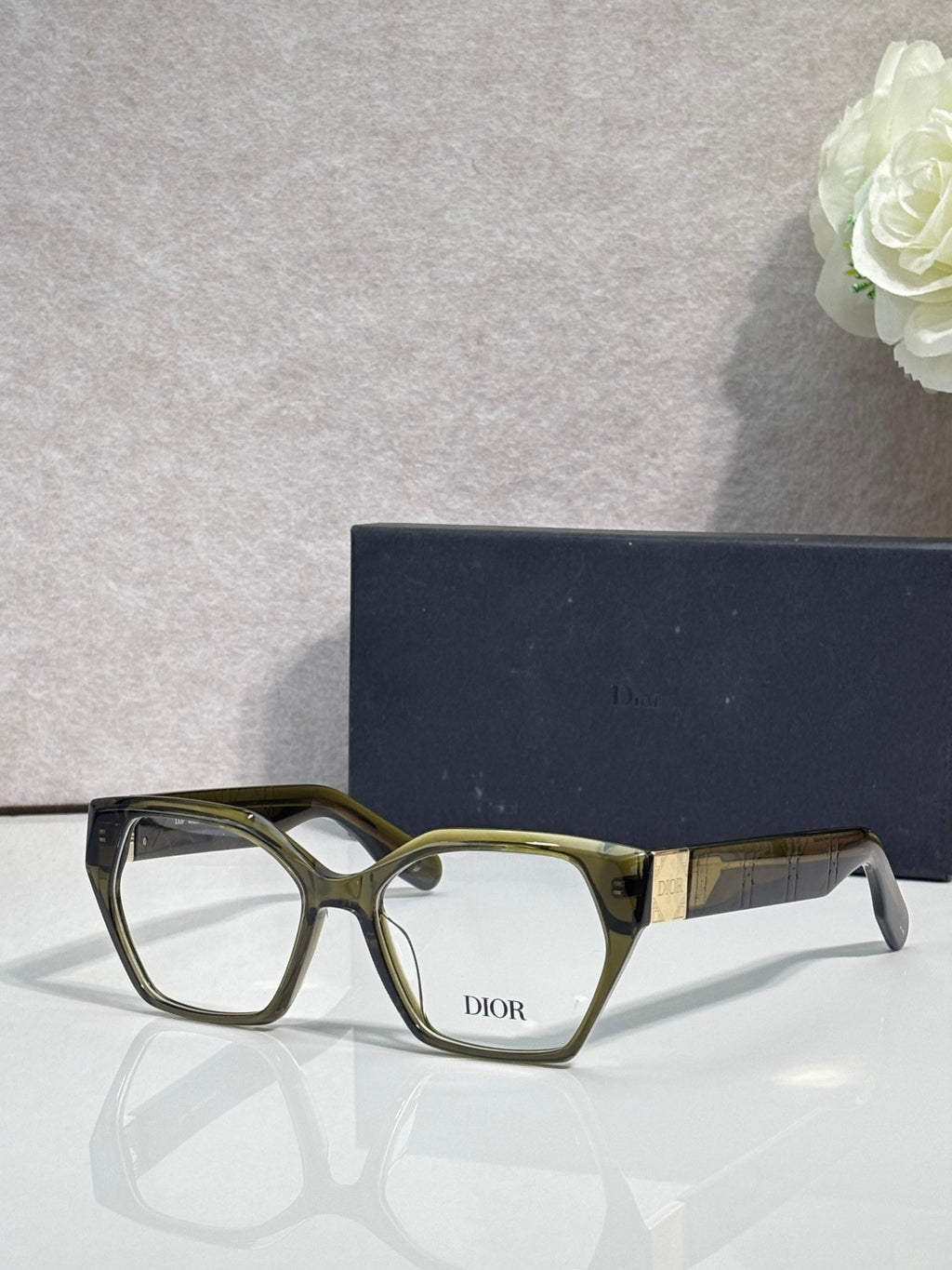 Dior eyeglasses, olive green frame with gold-toned temples, rectangular lenses
