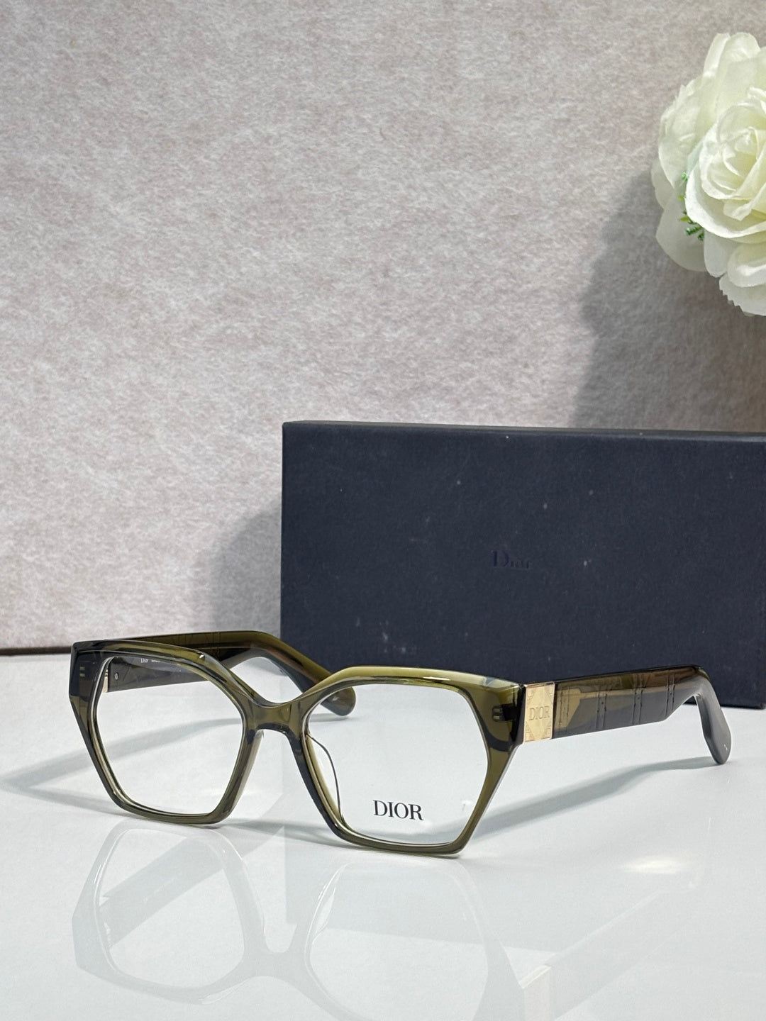 Dior eyeglasses, olive green frame with gold-toned temples, rectangular lenses