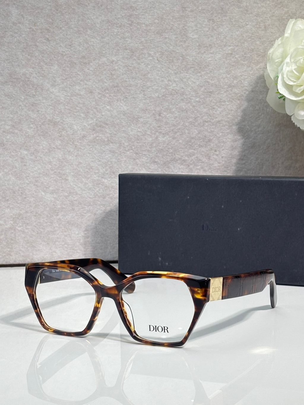 Dior eyeglasses, tortoise acetate frame with amber-striped temples, rectangular lenses