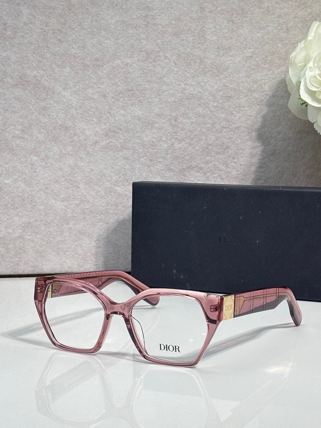 Dior eyeglasses, pink acetate frame with patterned temples, rectangular lenses