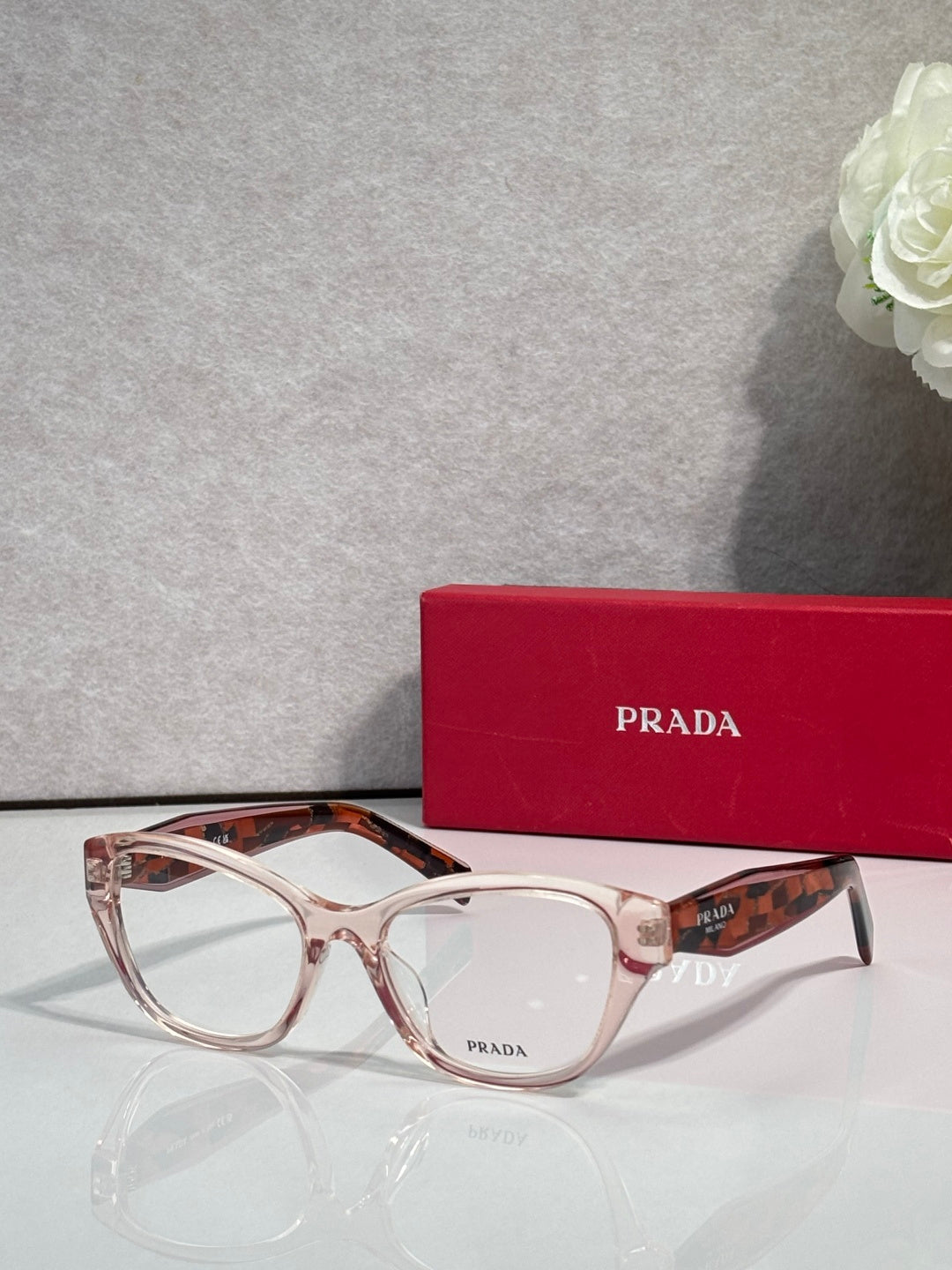 Transparent tortoiseshell Prada eyeglasses with rectangular frames and clear lenses