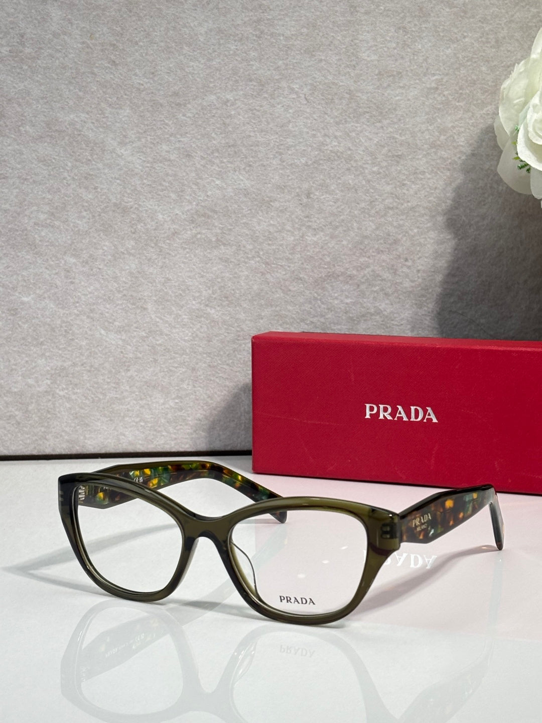 Green patterned Prada eyeglasses with rectangular frames and clear lenses
