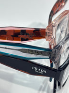 Prada eyeglasses temple close-up with multicolor striping and logo