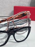 Prada eyeglasses close-up with layered frames in black and clear with logos